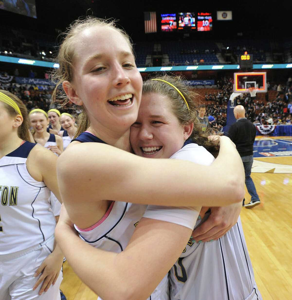 Lauralton’s Emma McCarthy and Carly Fabbri embrace after winning the Class LL girls basketball championship at Mohegan Sun Arena Saturday. (Mara Lavitt – New Haven Register)