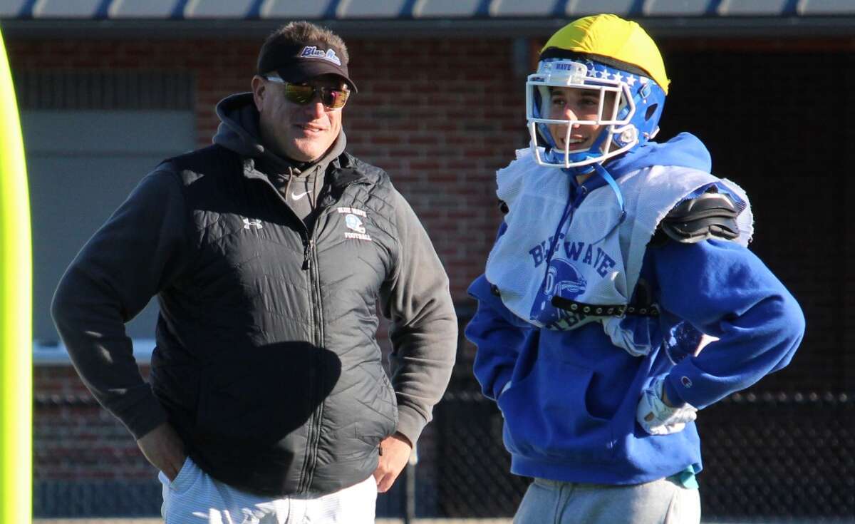 Darien Defensive Coordinator Mike Forget talks with a player during a practice on Thursday, Oct. 18, 2018 at Darien High School in Darien, Conn.