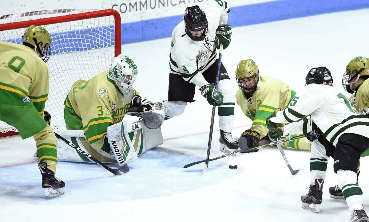 Notre Dame-West Haven goalie Connor Smith (left) defends against Luke Gfeller (center) and Colby Tuttle of Northwest Catholic in the third period of the CIAC Division I semi-final at Ingalls Rink in New Haven on March 13, 2019. Notre Dame-West Haven won 3-2.
