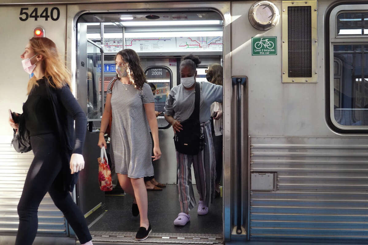 FILE - Commuters wearing face masks arrive in the Loop on an L train on July 27, 2021 in Chicago. (Photo by Scott Olson/Getty Images)