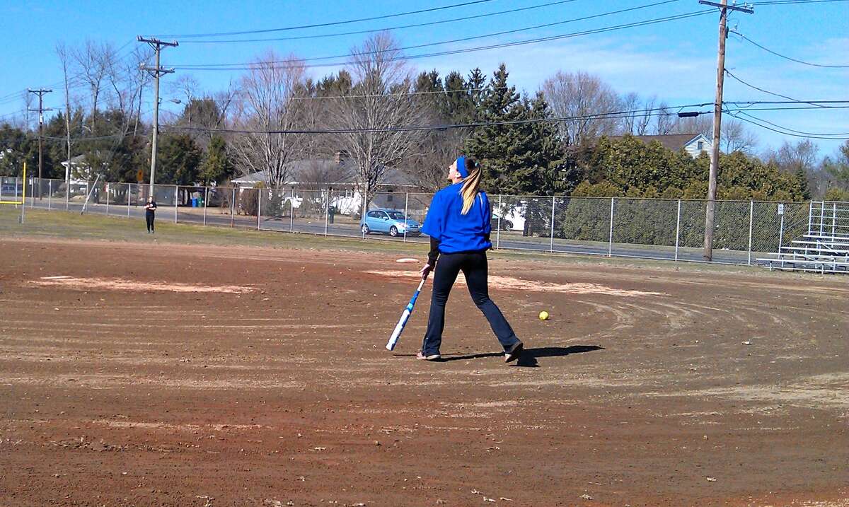 First-year Southington softball coach Davina Hernandez hits her outfielder’s fly balls Wednesday afternoon at practice.