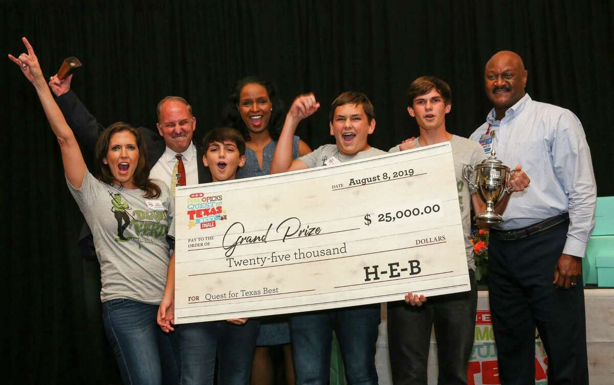 Traci Johannson (from left); Jody Hall (H-E-B), George Johannson; Winell Herring (H-E-B); Luke and Ayden Johannson; and James Harris (H-E-B) pose with the $25,000 prize the Johannsons won as 3 Sons Foods LLC in the H-E-B Quest for Texas Best statewide food competition.The sauce business based in Katy started as a way to expand fundraising efforts for rhino conservation.