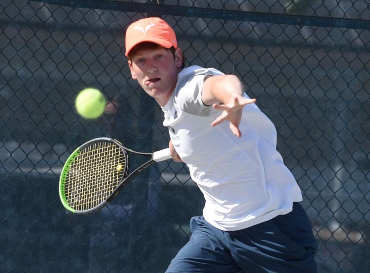 Staples’ Tighe Brunetti lines up a shot against Darien’s Chris Calderwood at No. 1 singles during the FCIAC boys tennis final in Wilton on Tuesday, May 25, 2021.