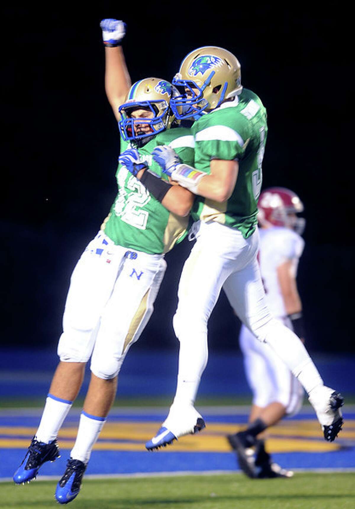 (Arnold Gold — New Haven Register) Nicholas Lotrecciano (left) of Newtown celebrates after a 46 yard reception in the opening set of downs against Bethel on 9/20/2013.