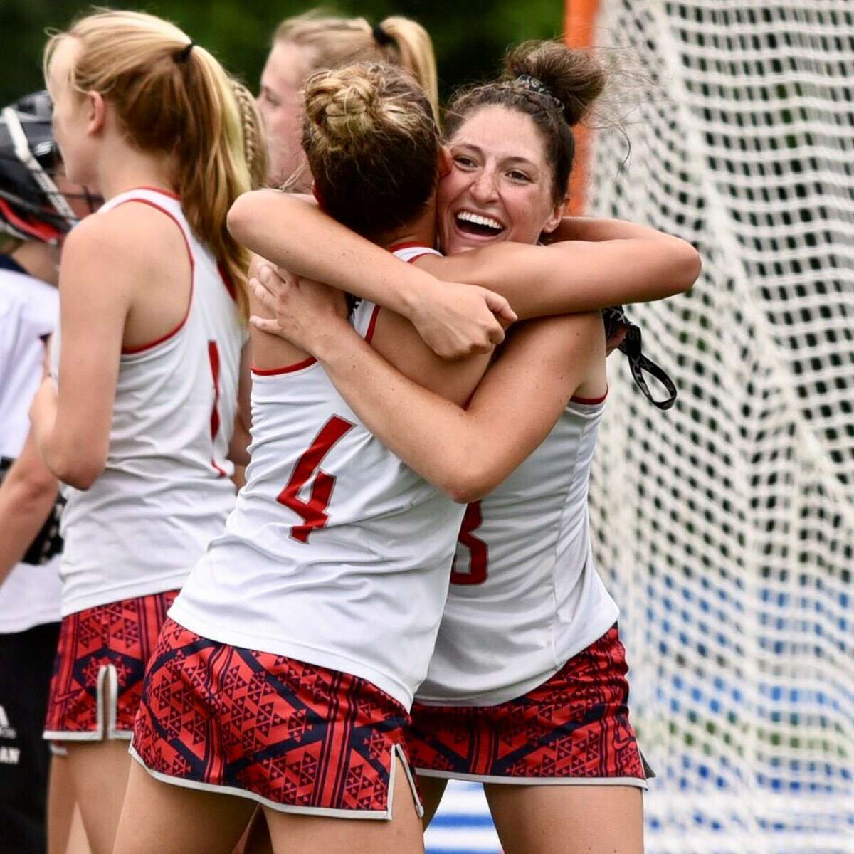 New Fairfield’s Jordan Siemonsen (4) and Reagan Tenaglia celebrate their 11-8 win over Weston in the CIAC girls lacrosse championship on Saturday, June 12, 2021 at Bunnell High School in Stratford, Conn.