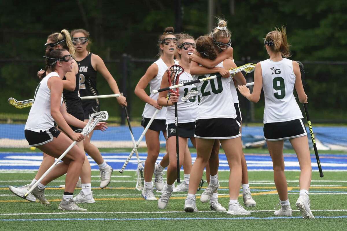 Guilford's Tyler Farace (5) hugs teammate Maddie Epke (20) as the Grizzlies celebrate a goal against Joel Barlow in the CIAC Class M girls lacrosse final at Bunnell in Stratford on Saturday, June 12, 2021.