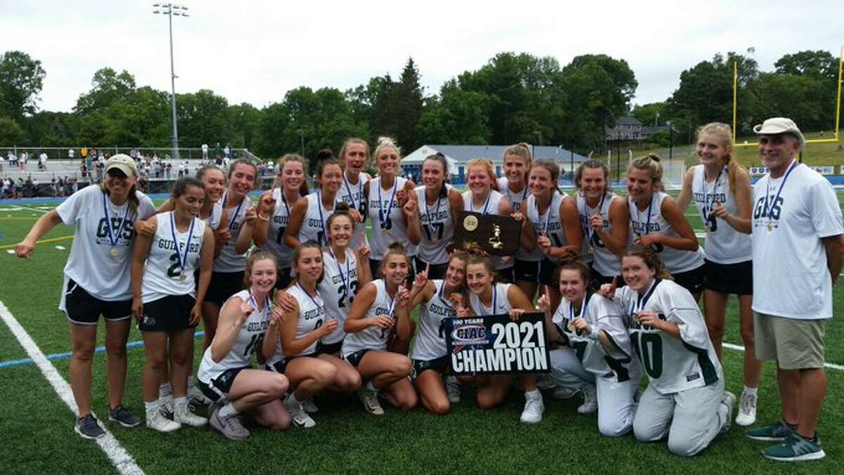 Guilford celebrates winning the CIAC Class M Girls Lacrosse title with an 11-10 win over Barlow on Saturday, June 12.