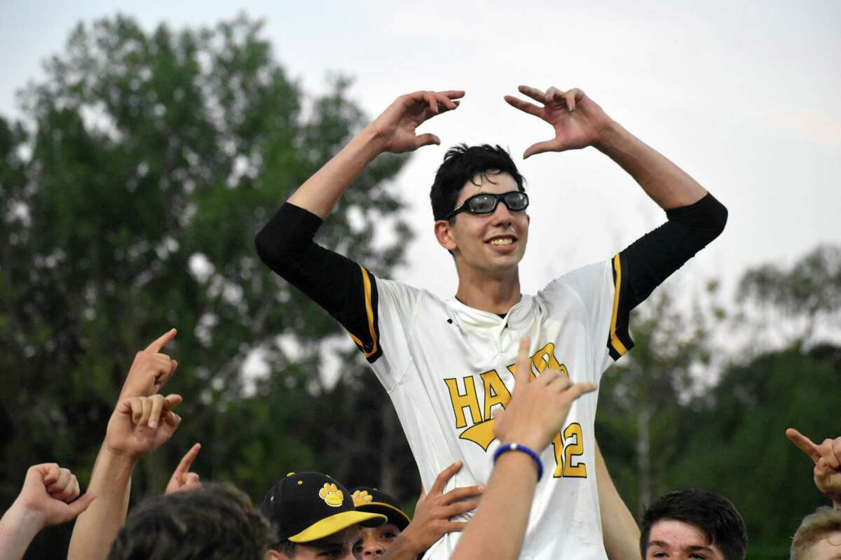 Hand's David Antonetti is lifted up by his teammates after he pitched a one-hitter in the Class L championship game at Palmer Field, Middletown on Saturday, June 12, 2021. (Pete Paguaga, Hearst Connecticut Media)