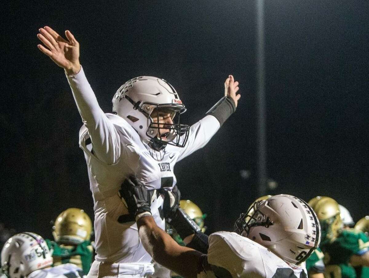 (John Vanacore/For Hearst Connecticut Media) Xavier’s Drew Kron(5) celebrates his first half touchdown with teammate Alex Math during their game with Notre Dame Friday night in West Haven.