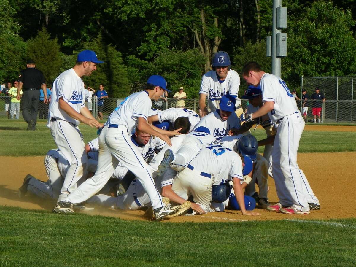 No. 8 Glastonbury celebrates around Joe Mercier after he executes a bunt to drive in John Rosadino on a safety squeeze in the bottom of the ninth to beat No. 25 Wilton, 6-5 at Riverfront Park in Glastonbury.
