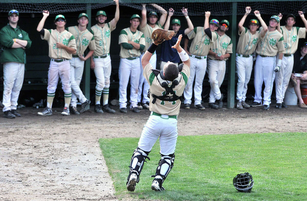 Notre Dame catcher Aiden Burton goes after a pop fly as his team looks on during the Class L semifinals. (Photo Arnold Gold)