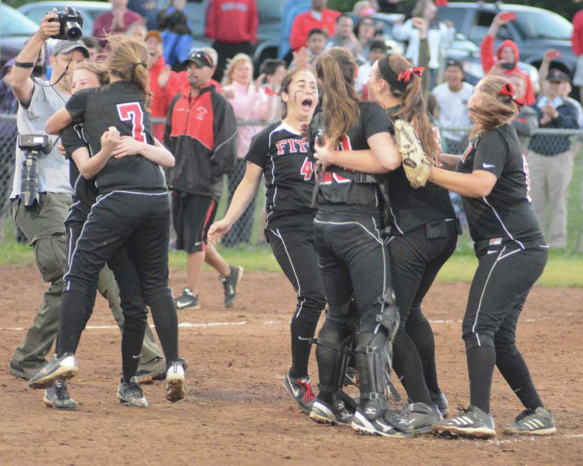 (Photo by Dave Phillips)  The Fitch softball celebrates its Class L state championship over Sacred Heart Academy.
