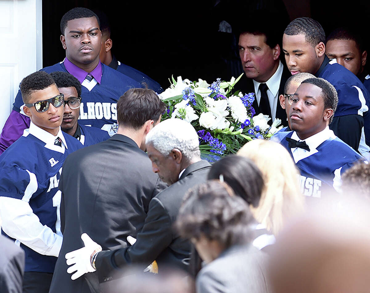 Members of the Hillhouse High School football team carry the casket of Jacob Craggett out of the Christian Tabernacle Baptist Church in Hamden on Aug. 16. Arnold Gold-New Haven Register)