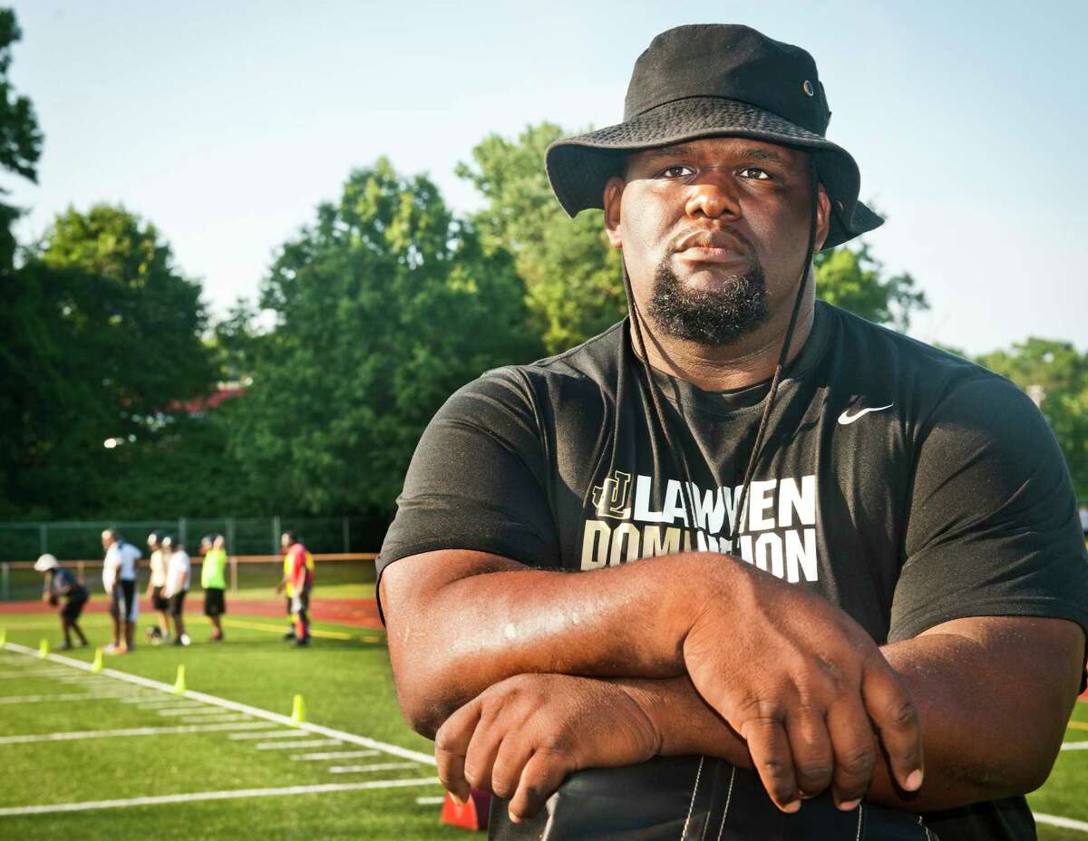 Derrick Lewis, a West Haven native and former standout football player at SCSU.starts his first year coaching football at Law, moving over from Bassick. (Melanie Stengel – Register)