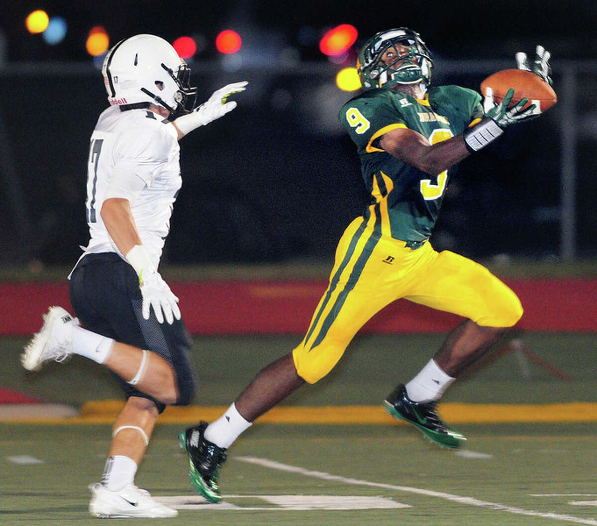 Nathan McCary (right) of Hamden intercepts a pass intended for Noah Palo (left) at the end of the first half on 9/27/2013. Photo by Arnold Gold/New Haven Register