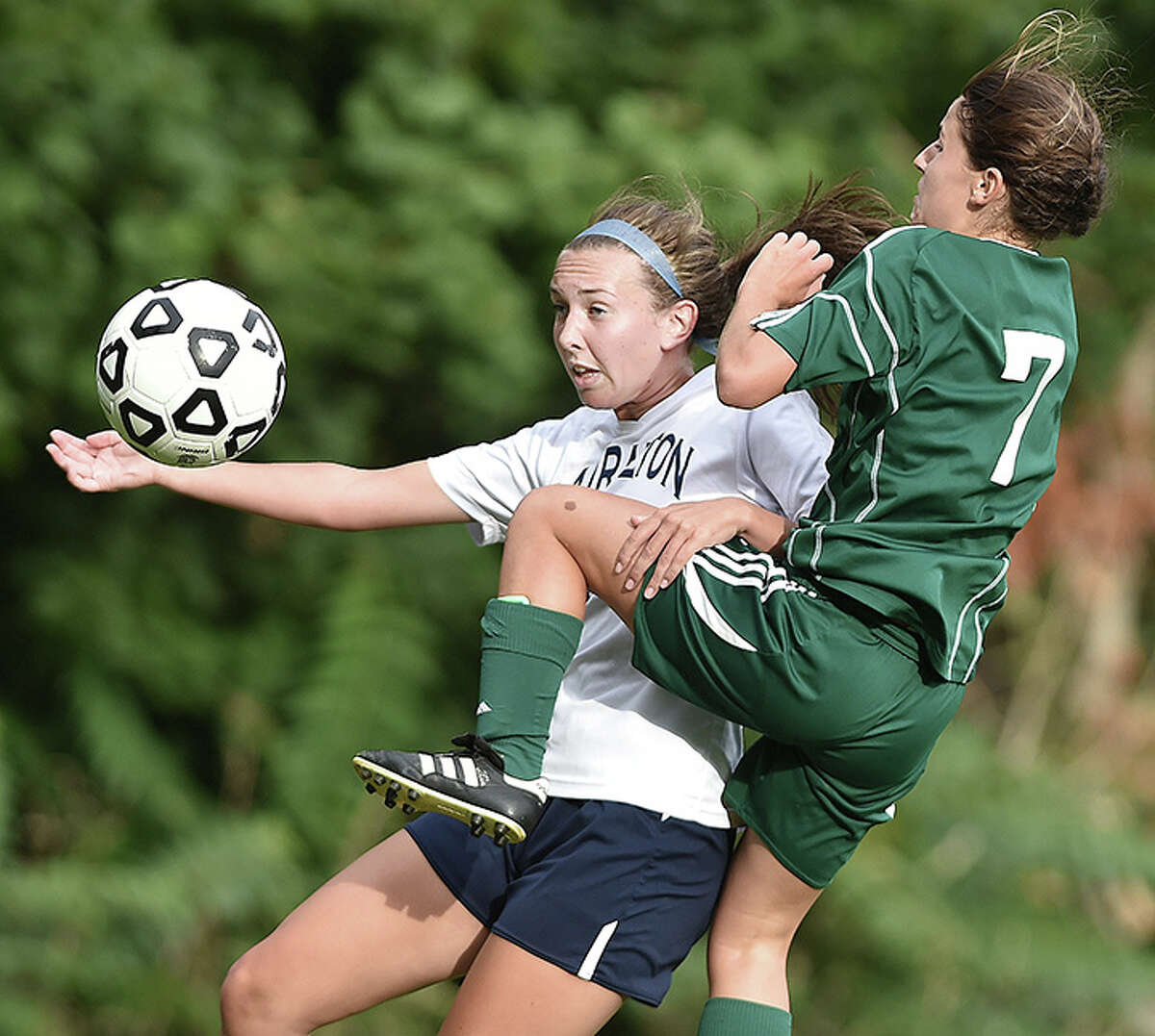 Lauralton Hall senior captain Suzanne Lema battles Guilford junior midfielder Emma Rusconi during the second half of their first game in the SCC in Milford Tuesday afternoon. The Lauralton Hall Crusaders defeated the Guilford Indians, 1-0. (Catherine Avalone – New Haven Register)