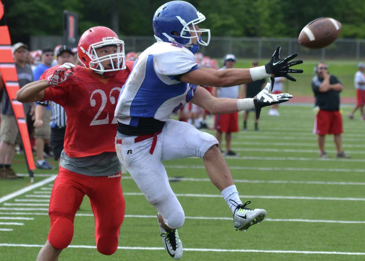 Southington wide receiver Alex Jamele pulls in a pass during a scrimmage vs. Masuk last week. Jamele set the state receiving TD record last year and will be a force for the Blue Knights once again in 2014. Pete Paguaga – New Haven Register