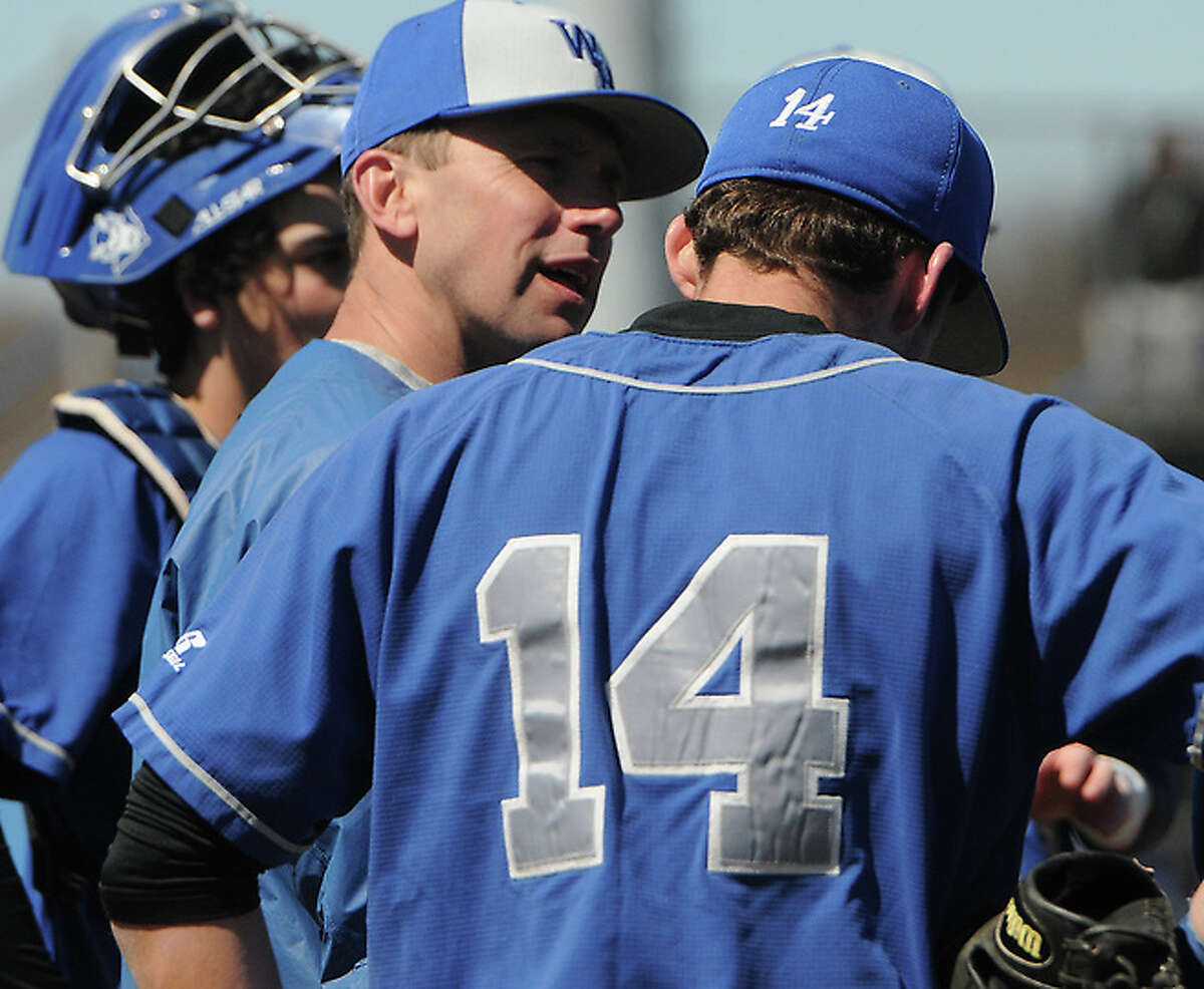 West Haven baseball coach Mike Anquillare (center) talks with a pitcher during a game in 2012. Anquillare announced he will step down after 15 years as head coach (Photo Peter Hvizdak)
