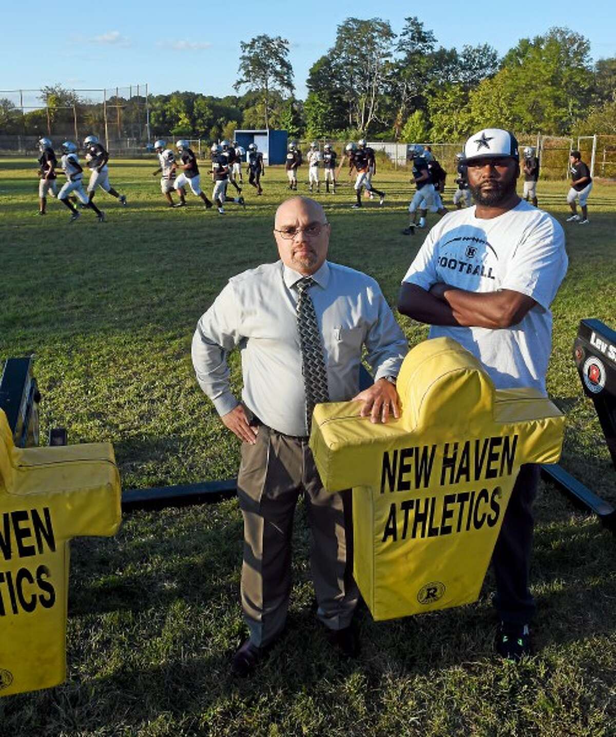 Bill Oliver, left, and Juan Gardner, parents of Hillhouse High School football players who are disturbed that the school’s football will have no home games this year because of dangerous chemicals found on Bowen Field in New Haven. Wednesday, September 17, 2014. (Peter Hvizdak ­— New Haven Register)