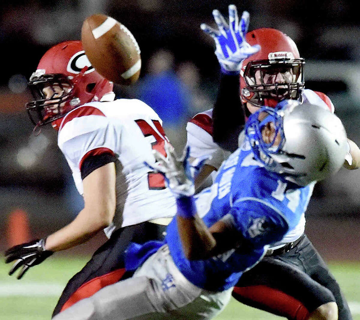 (Peter Hvizdak – New Haven Register) Zatrell Lyons of West Haven H.S. can’t hold onto the ball, center, as the pass play is broken up by Cheshire High School defensive backs Nate Hilburn, left, Brian Weyrauch during second quarter football action Friday (Photo Peter Hvizdak, Register)