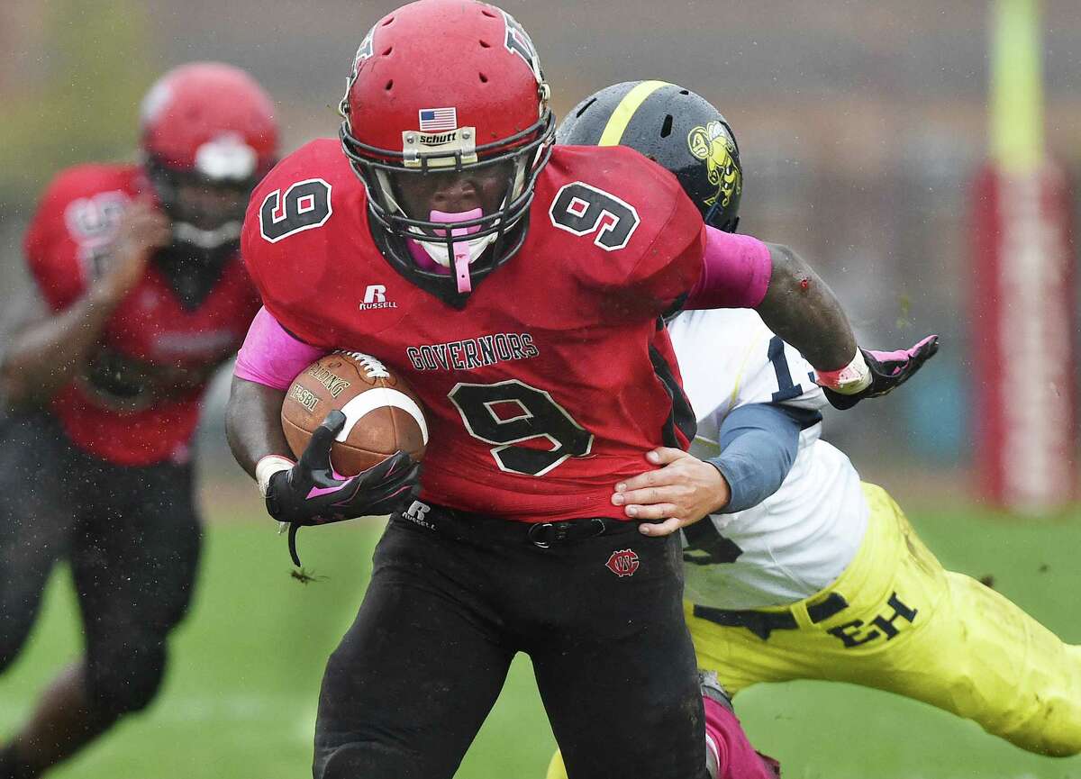 Wilbur Cross junior Ricky Bunn fends off East Haven junior Sal Luzzi at the Barbarito/Marone Football Field at Wilbur Cross High School in New Haven Saturday morning, The Wilbur Cross Governors defeated the East Haven Yellowjackets 60-18. (Catherine Avalone – New Haven Register)