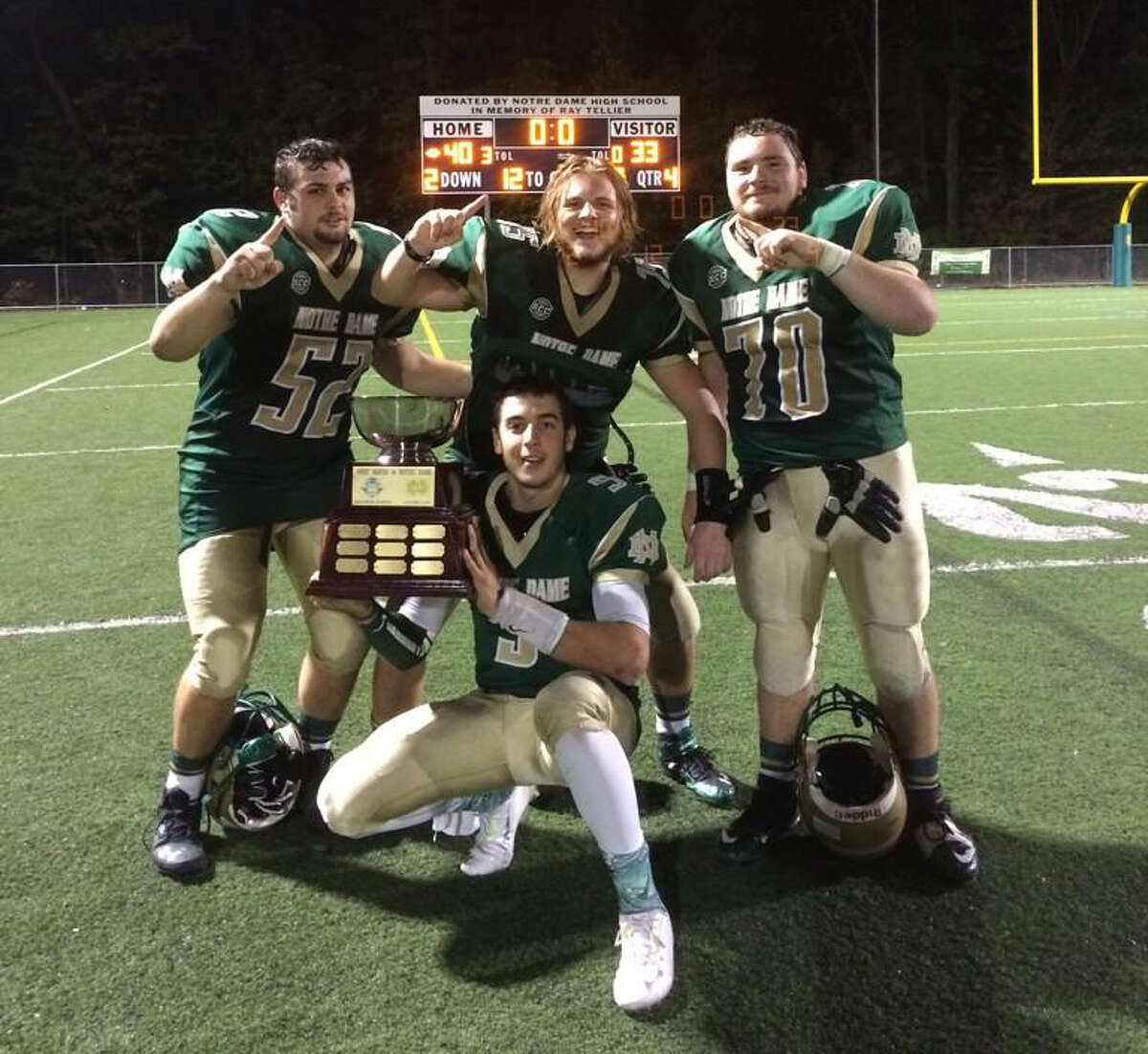 Notre Dame senior linemen Owen Barnell, Kyle Cullen and Joe Petrosino celebrate with the Soderman Bowl trophy with QB Christian Lupoli (Photo via Twitter by @ND_Greenmachine)