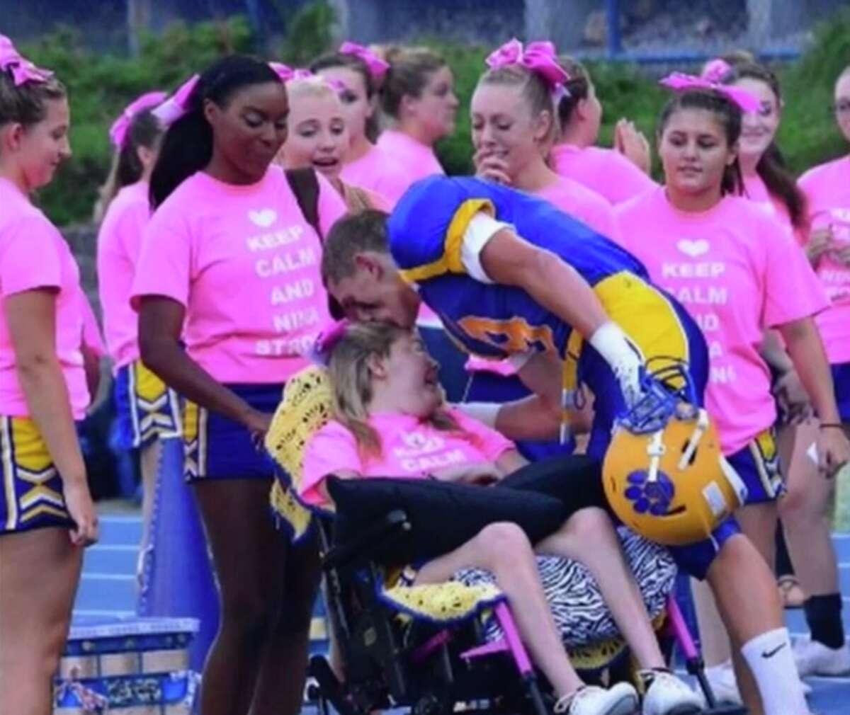 Seymour’s Nina Poeta gets a pregame kiss from boyfriend and Seymour football player Jake Bleau before the Wildcats’ home-opener this year. Poeta has inoperable brain cancer and communities from across the Valley and beyond have rallied to their cause (Screen Cap via CPTV Sports)