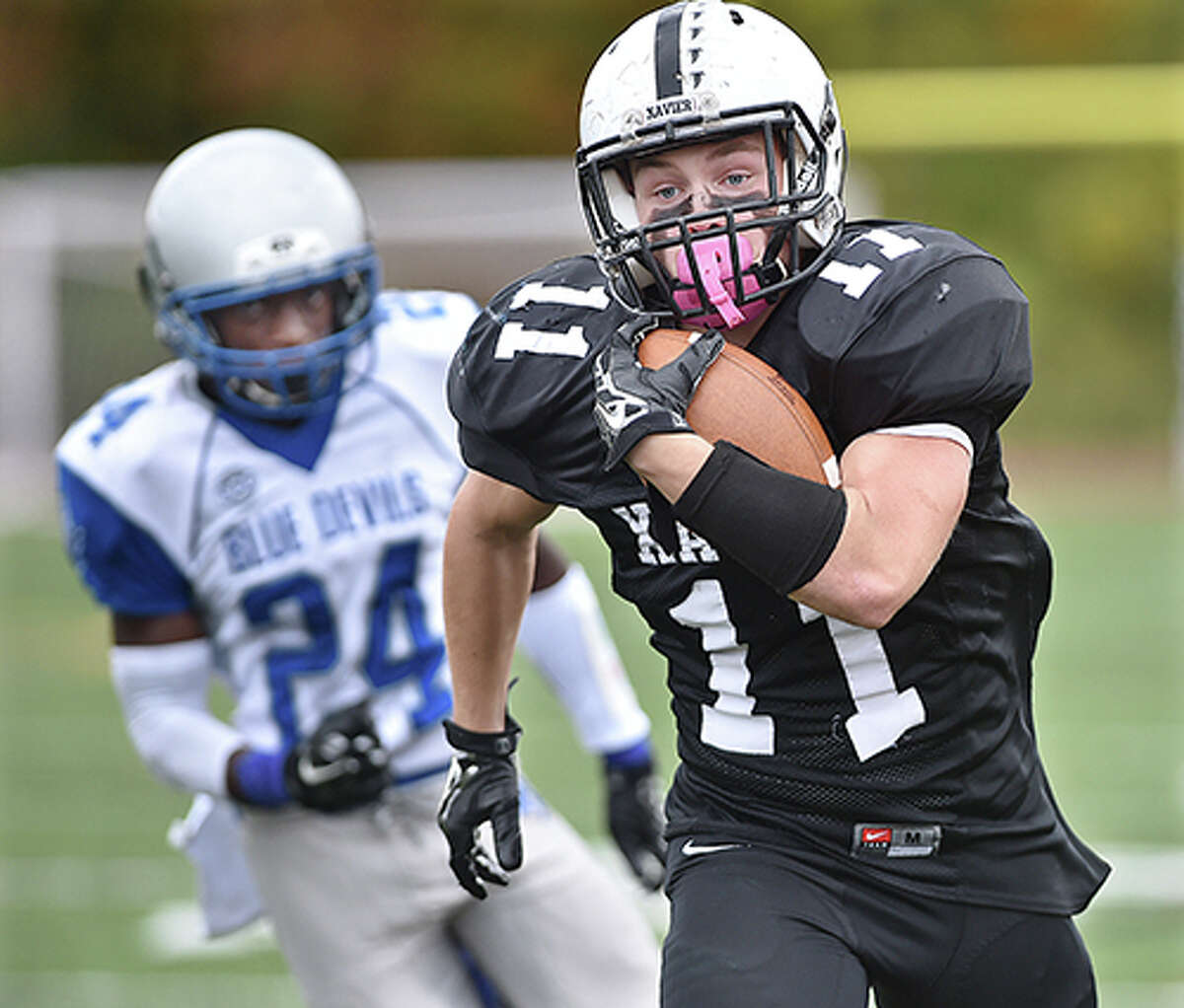 Xavier’s Robert Baldo runs for a touchdown in the fourth quarter as West Haven’s Drew Highsmith defend Saturday afternoon, October 18, 2014 at the newly dedicated Larry McHugh Field at Xavier High School in Middletown. The Xavier Falcons defeated the West Haven Blue Devils 27 -7. (Catherine Avalone – New Haven Register)