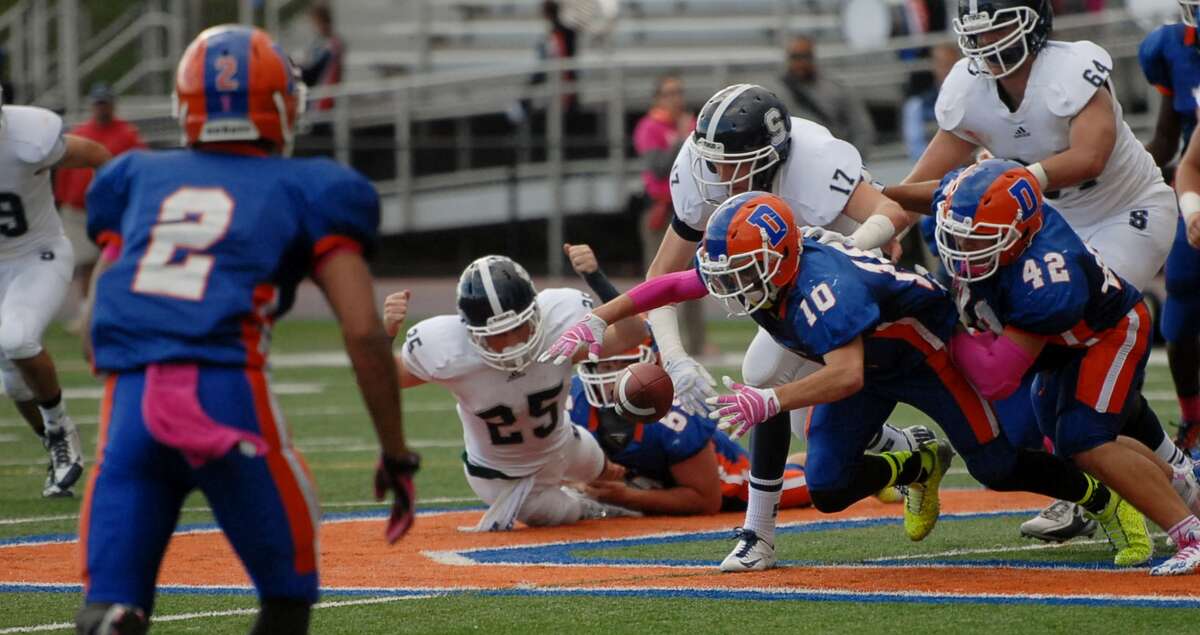 Danbury’s defense pounces on a loose ball during the first half of play Saturday afternoon against Staples.