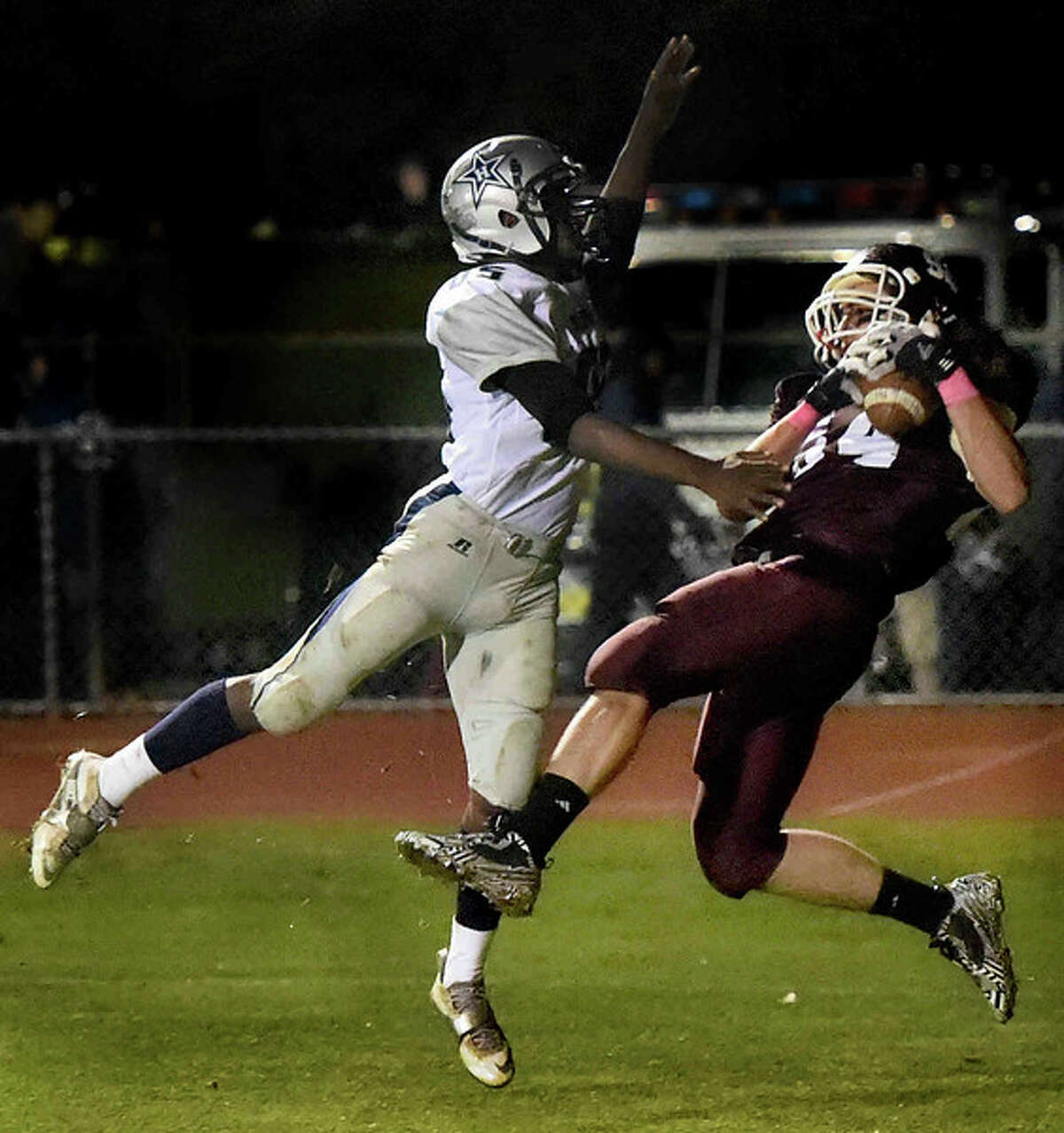 Mehdi Azizi of North Haven High School pulls in touchdown pass, right, over Gabriel Abdul-Karim of Hillhouse (Photo by Peter Hvizdak – New Haven Register)