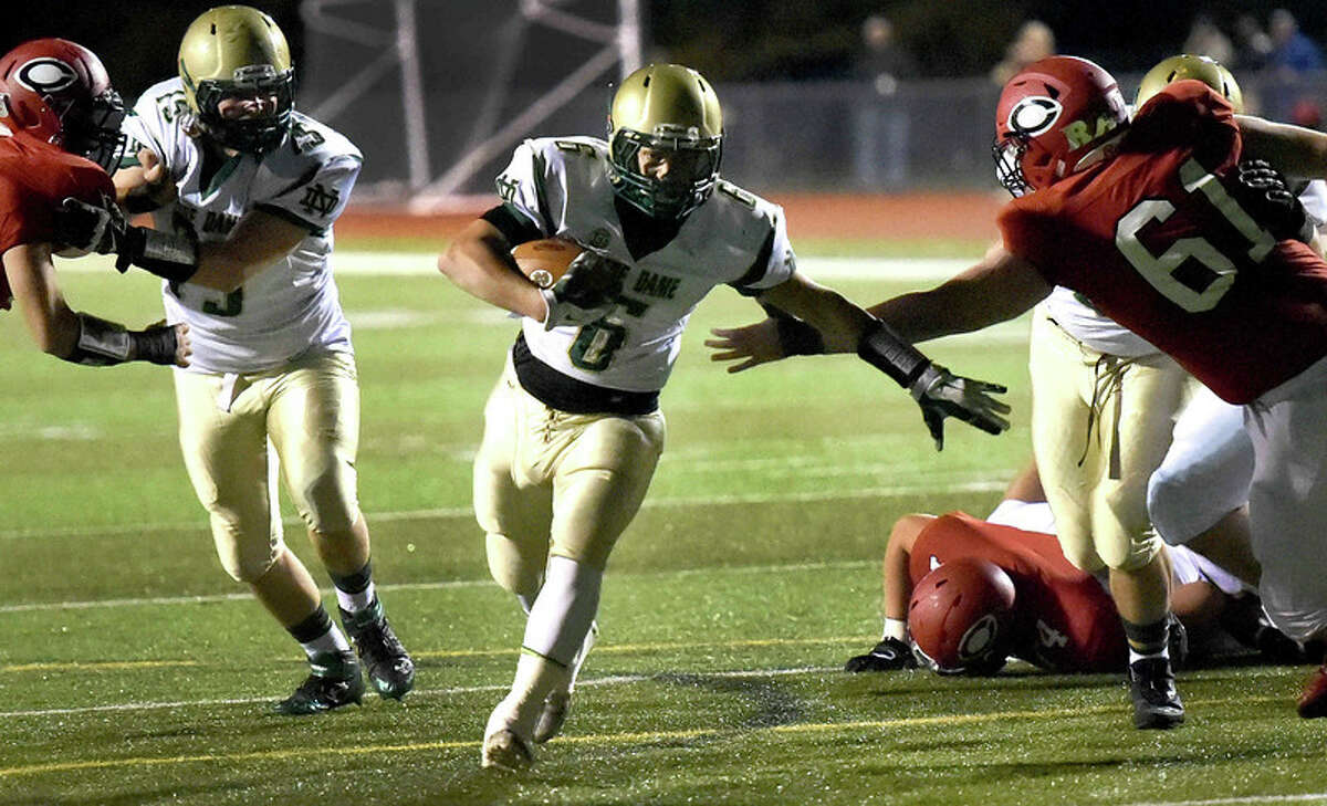 Josh Witkowsky of Notre Dame H.S. runs for a touchdown past Cullen Clairmont of Cheshire H.S. during first quarter football action at Cheshire H.S. Friday evening, October 31, 2014. (Photo by Peter Hvizdak – Register)