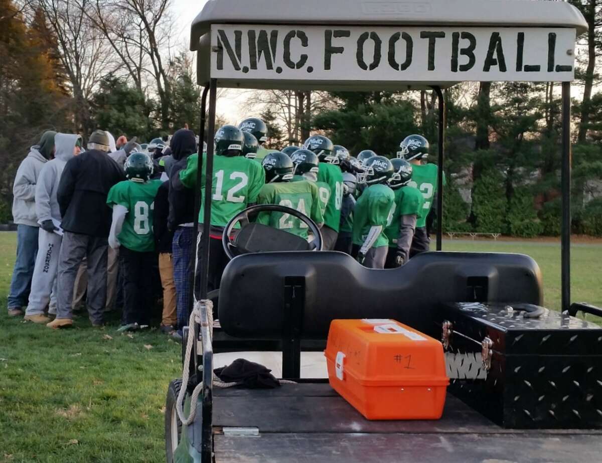 The Northwest Catholic football teams comes together at practice this season. Head coach Mike Tyler is finishing out his 15th and final season with the team. Derek Turner-GameTimeCT