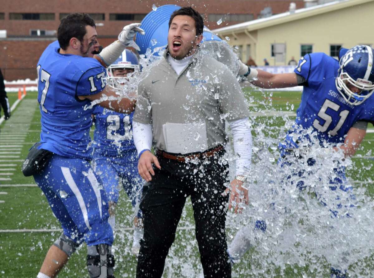 Southington coach Mike Drury is doused by Steve Hamel (17) and Matt Thomson after winning the Apple Valley Classic, 44-7 over Cheshire (Photo Peter Paguaga)