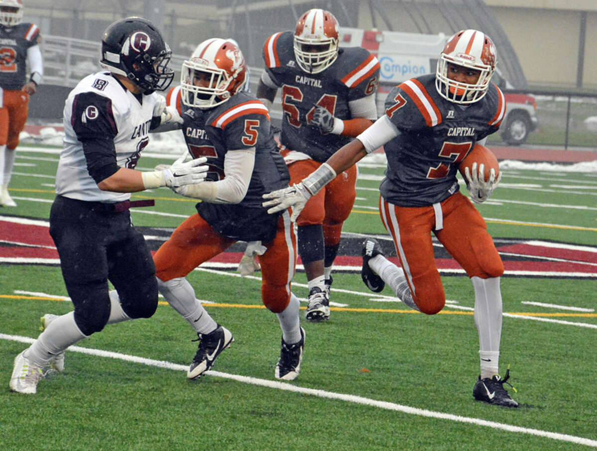 With the help of teammate Dexter Lawson (5), Capital Prep/AF’s Terrell Boseman (7) looks upfield for running room. Gerry deSimas, Jr./ Collinsville Press.com