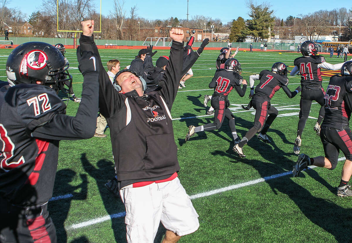 Valley Regional / Old Lyme coach Tim King raises his arms in joy as his team celebrates their 21-20 comeback victory over Ansonia (Photo John Vanacore)
