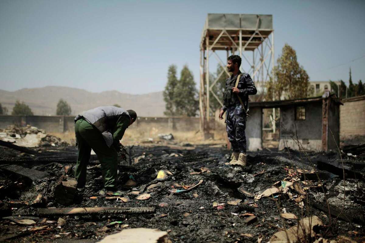 Yemeni police inspect a site of Saudi-led airstrikes targeting two houses in Sanaa, Yemen, Saturday, March 26, 2022. Yemen's warring sides have accepted a two-month truce, starting with the Muslim holy month of Ramadan, the U.N. envoy to Yemen said Friday, April 1. (AP Photo/Hani Mohammed, File)