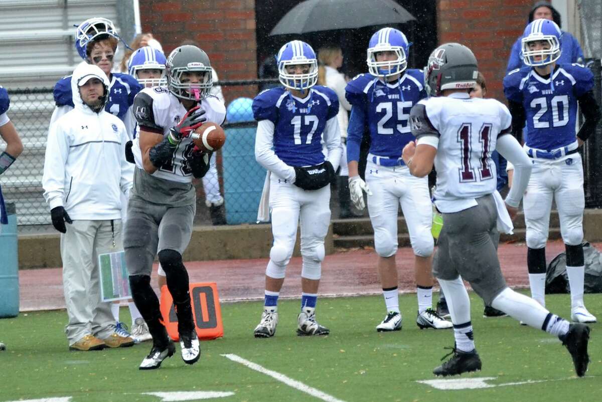 Naugatuck’s Bryan Coney (left) catches a pass during the Class L-Large playoffs at Darien (Photo Pete Paguaga)