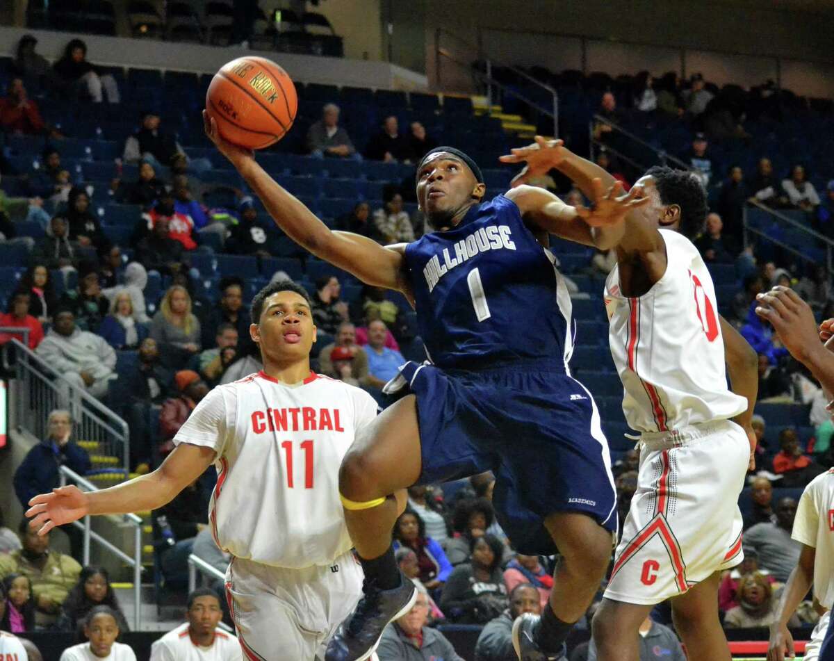 Hillhouse’s Dontell Glover Jr. gets hit as he goes up for a layup in Hillhouse’s 68-51 win over Bridgeport Central. (Pete Paguaga – Register)