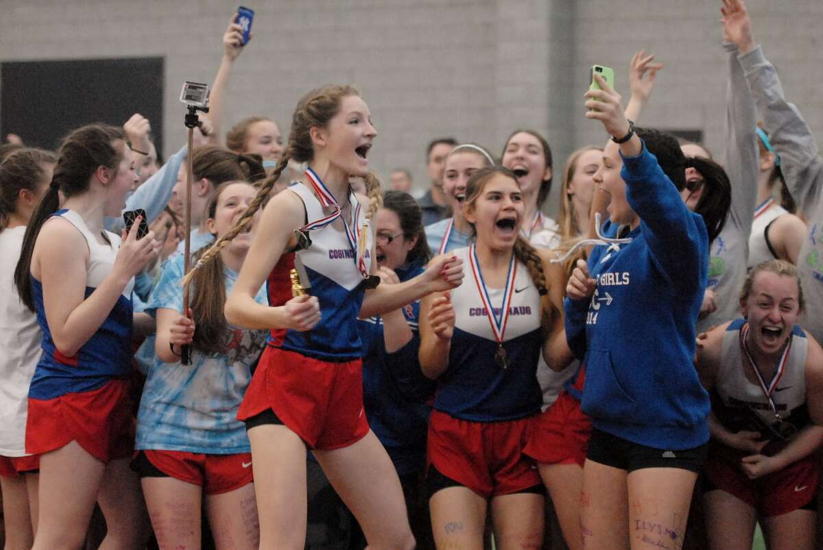 Members of the Coginchaug girls’ track team celebrate after winning the Shoreline Conference Indoor Track title on Saturday at the Floyd Little Athletic Center. Photo by Mary Albl