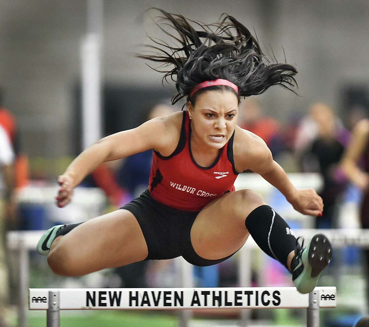 Wilbur Cross junior Gabby Curtis won the 55 meter hurdles in 8.48, at the CIAC Class L Indoor Track and Field Championships, Friday. Curtis and her teammates won the championship with 76 points, 20 points ahead of the Darien Blue Wave. (Catherine Avalone/New Haven Register)