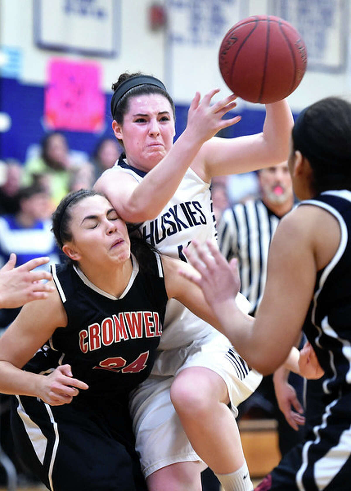 Alyssa Wright (left) of Cromwell collides with Tori Hopkins of Morgan as she drives to the basket in the first half in Clinton on 2/16/2015. Photo by Arnold Gold/New Haven Register