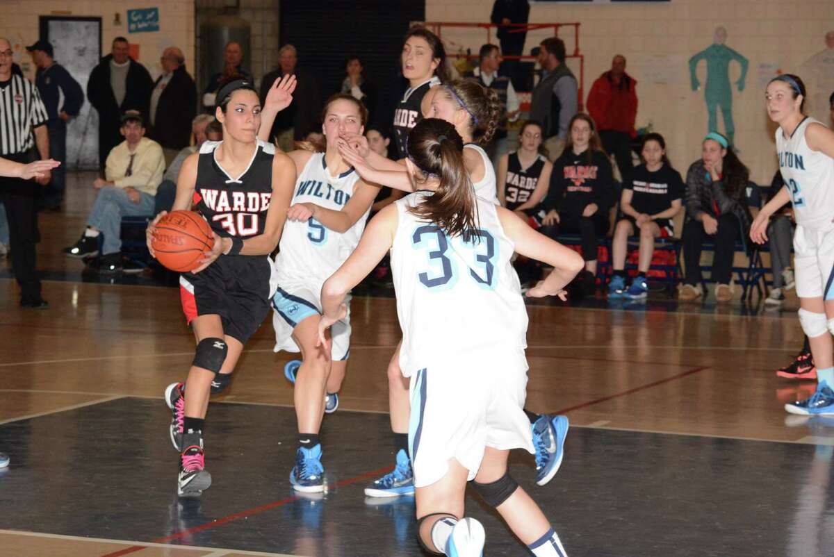 Fairfield Warde’s Sarah Cotto drives to the basket Wednesday evening against Wilton. Photo by Andy Hutchison
