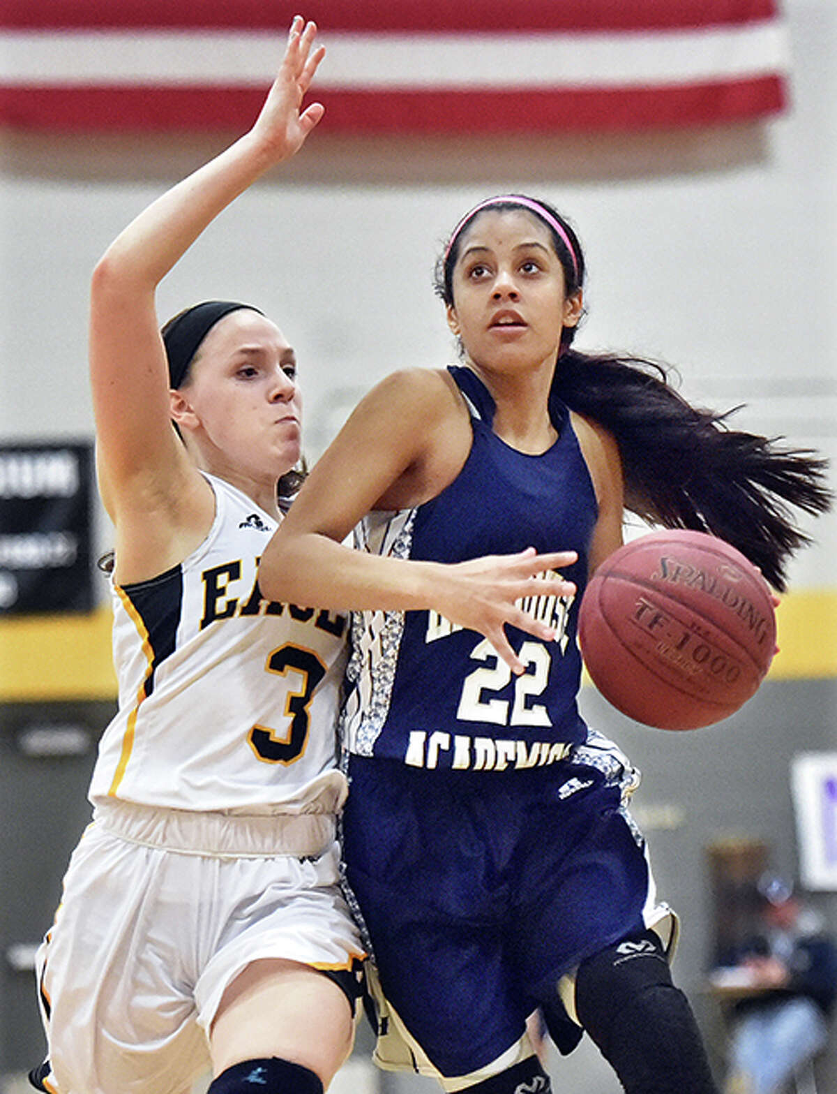 Hillhouse guard Allegra Jones drives the paint as Law’s Brook Hiatt defends in the SCC First Round game, Thursday, February 19, 2015. The Hillhouse Academics defeated the Law Eagles, 49-43, at Jonathan Law High School gymnasium in Milford. (Catherine Avalone – New Haven Register)