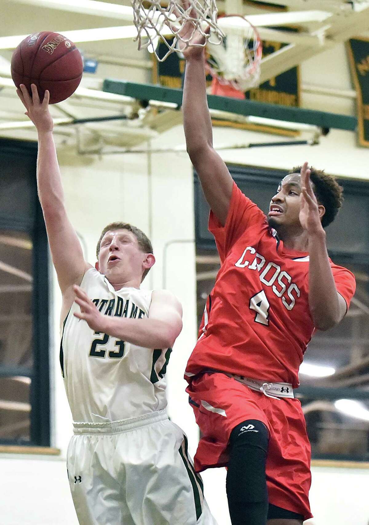 Notre Dame’s Ben Bagnoli goes to the basket as Wilbur Cross’ Jaykeen Foreman defends in the SCC tournament opening round Thursday.