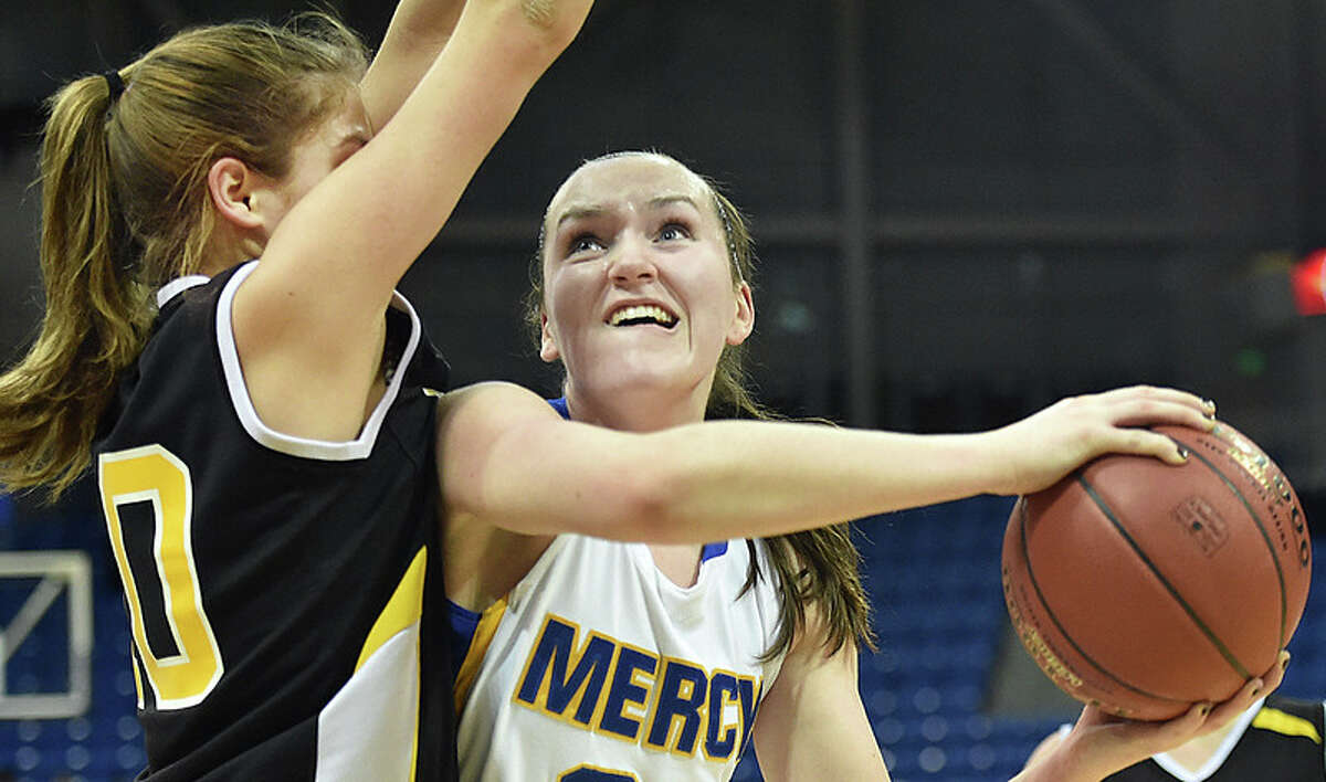 Mercy’s Maura Fitzpatrick eyes the hoop as Hand’s Lauren Brandau defends during the SCC Girls Basketball Championship game.(Photo Catherine Avalone)