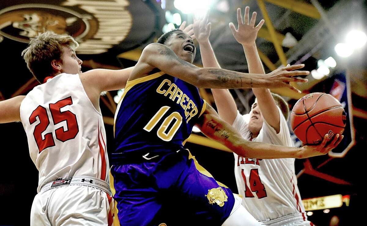 Career’s Tyreek Perkins scores two of his 13 pts. as Fairfield Prep’s Patrick Harding (25) and Richard Kelly (14) in a 81-59 SCC championship win over the Jesuits, Wednesday, March 4, 2015, at TD Bank Sports Center at Quinnipiac University in Hamden (Catherine Avalone – New Haven Register)