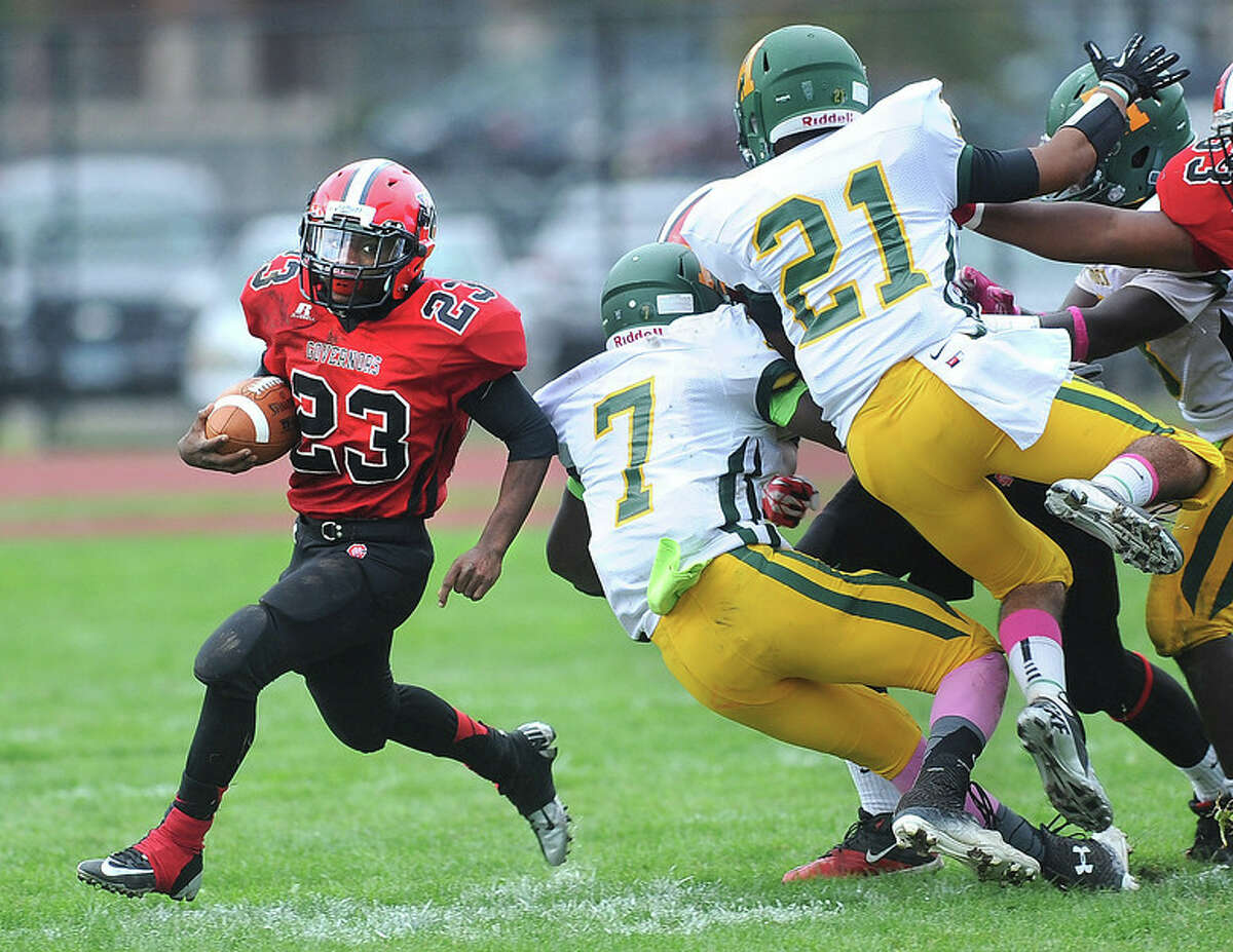 (Peter Casolino – New Haven Register) Wilbur Cross’ Stevie Swinson gets around the corner for a long gain in the 3rd quarter as Hamden’s Nigil Tappin (#7) and Emmanuel Hernandez defend.