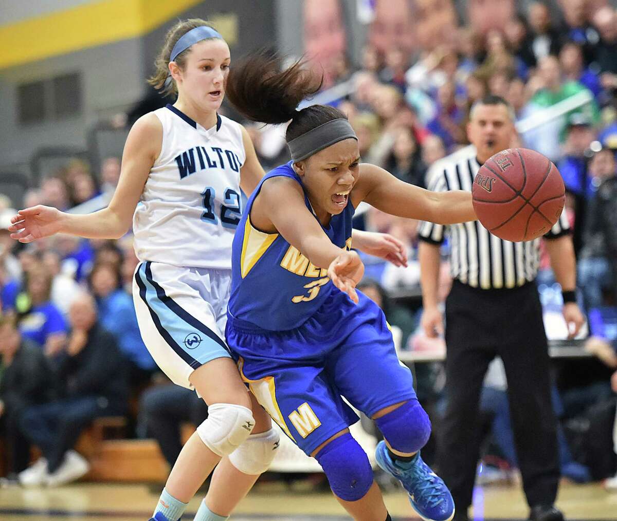 Mercy’s Destine Perry drives to the paint around Wilton’s Haley English in the CIAC Class LL semifinal game, Monday, March 16, 2015, at Jonathan Law High School in Milford. The Wilton Warriors defeated the Mercy Tigers, 55-54. (Catherine Avalone/New Haven Register)