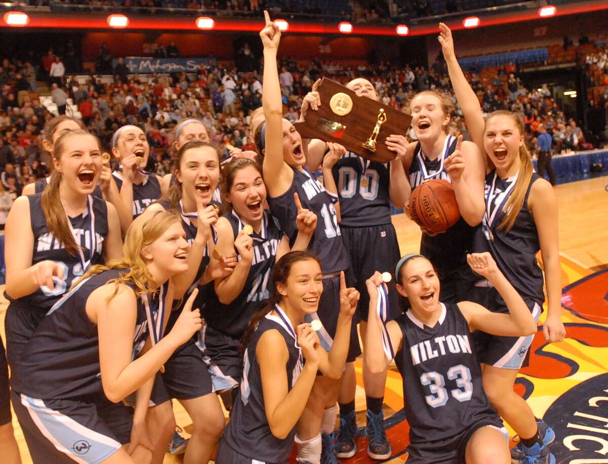 The Wilton girls’ basketball team celebrates its Class LL state title. Photo by Mary Albl