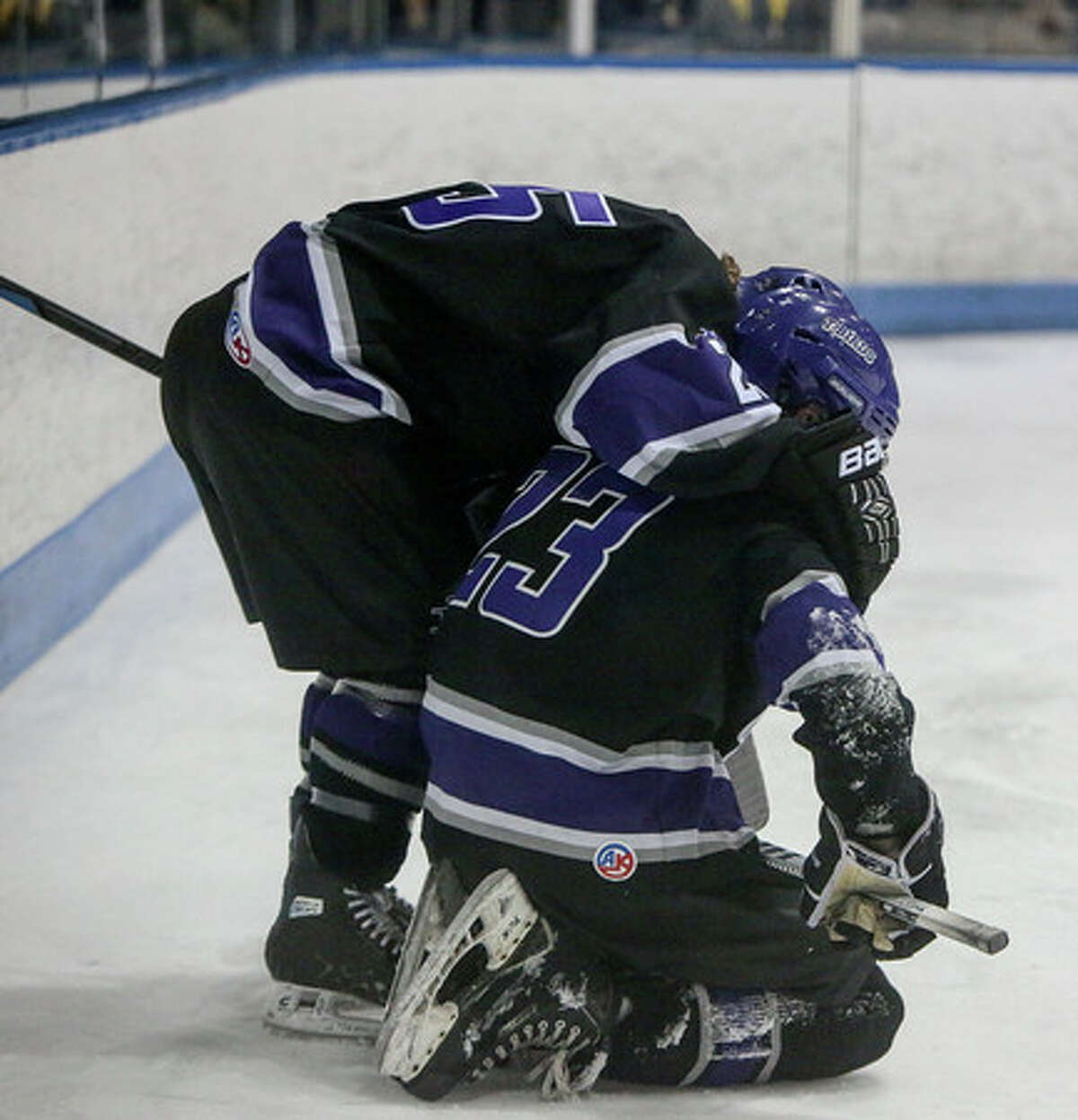 North Branford’s Tanner Opie is consoled by one of his teammates following a Division II hockey final loss to Suffield/Granby/Windsor Locks. (Photo John Vanacore)